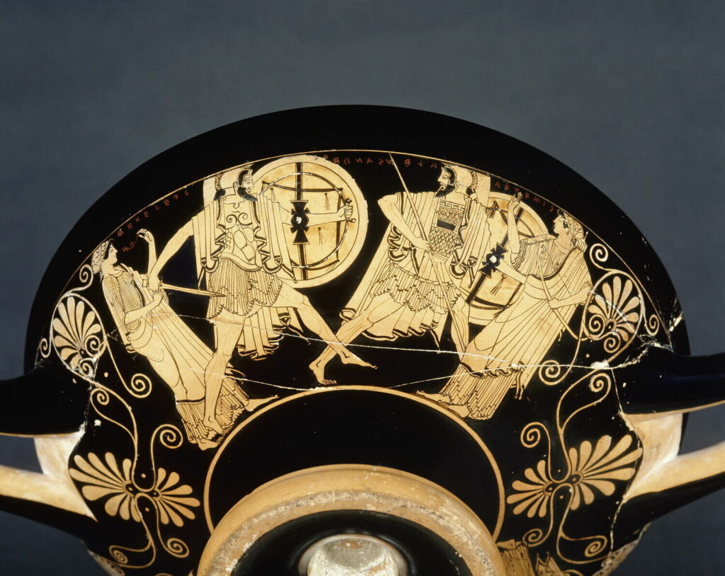a Greek red-figure vase painting; two warriors are in conflict at the center; a female figure flanks them on either side