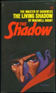 Steranko's cover for the first book in Pyramid's reprint series of  novels from the pulp magazine THE SHADOW.

image shows a man's face, partly concealed by the brim of his hat and the red-lined collar of a black cape; he has a pretty sizeable schnozz on him